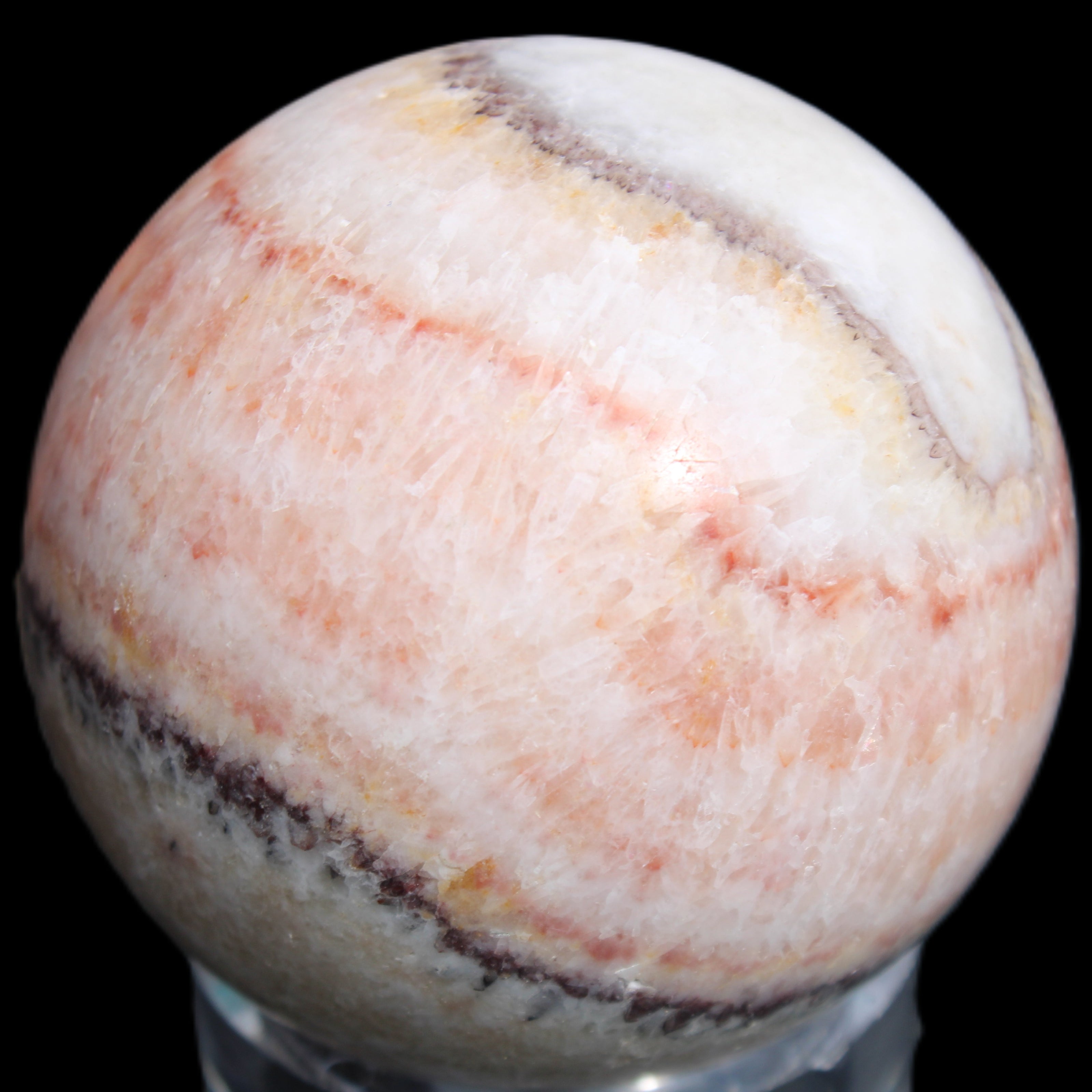 Rhodochrosite sphere 320g in sunlight - Rocks and Things Store