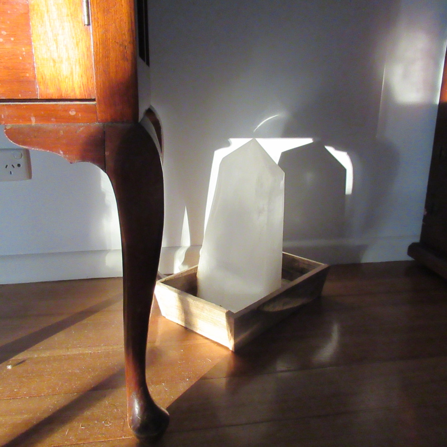 Clear White Quartz obelisk 14040g inside in a stray low evening sunbeam