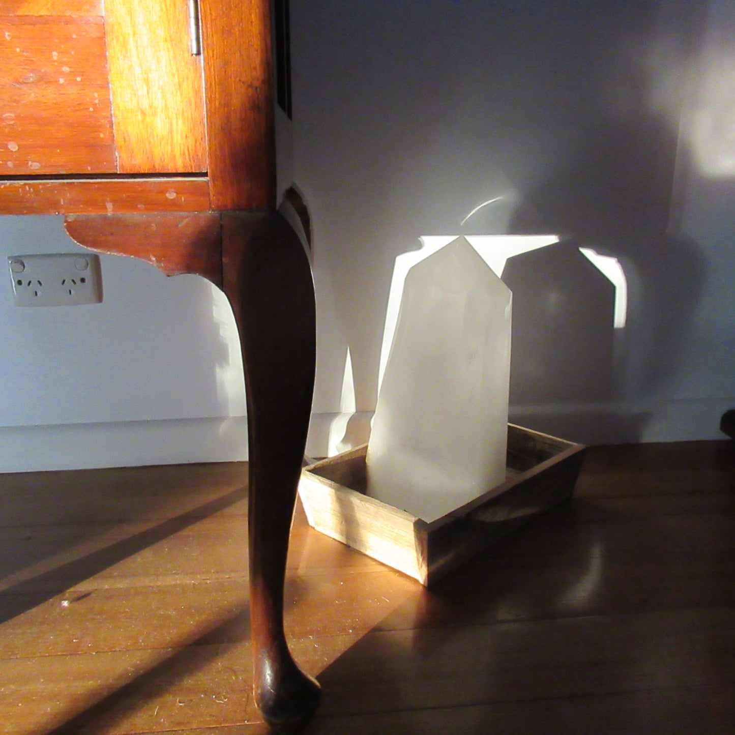 Clear White Quartz obelisk 14040g inside in a stray low evening sunbeam