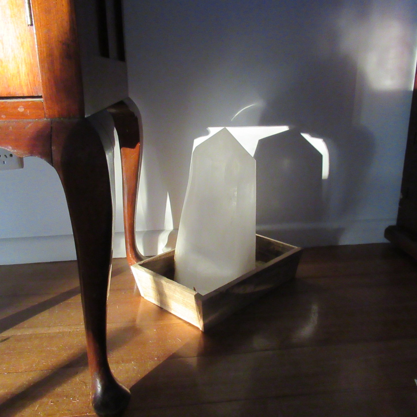 Clear White Quartz obelisk 14040g inside in a stray low evening sunbeam