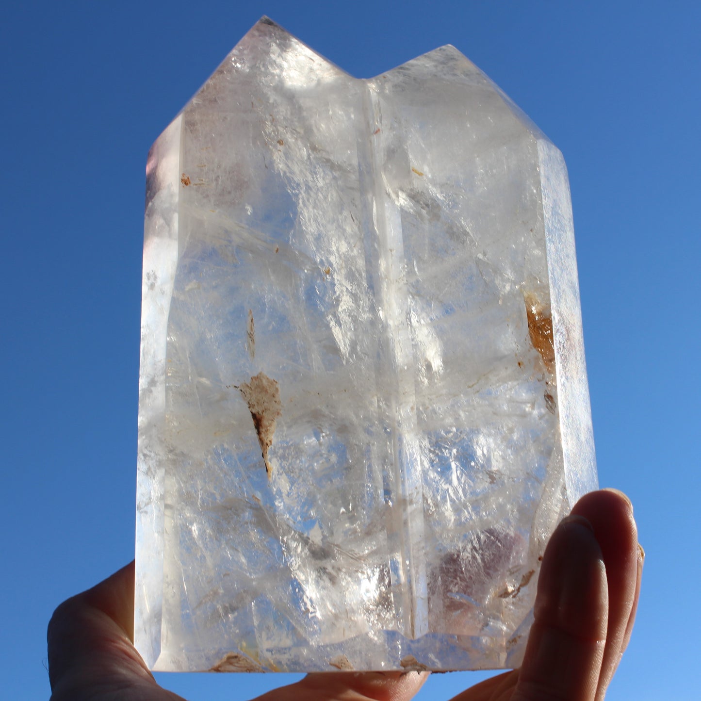 Clear Quartz double-pillar obelisk 1655g in sunshine, held in hand