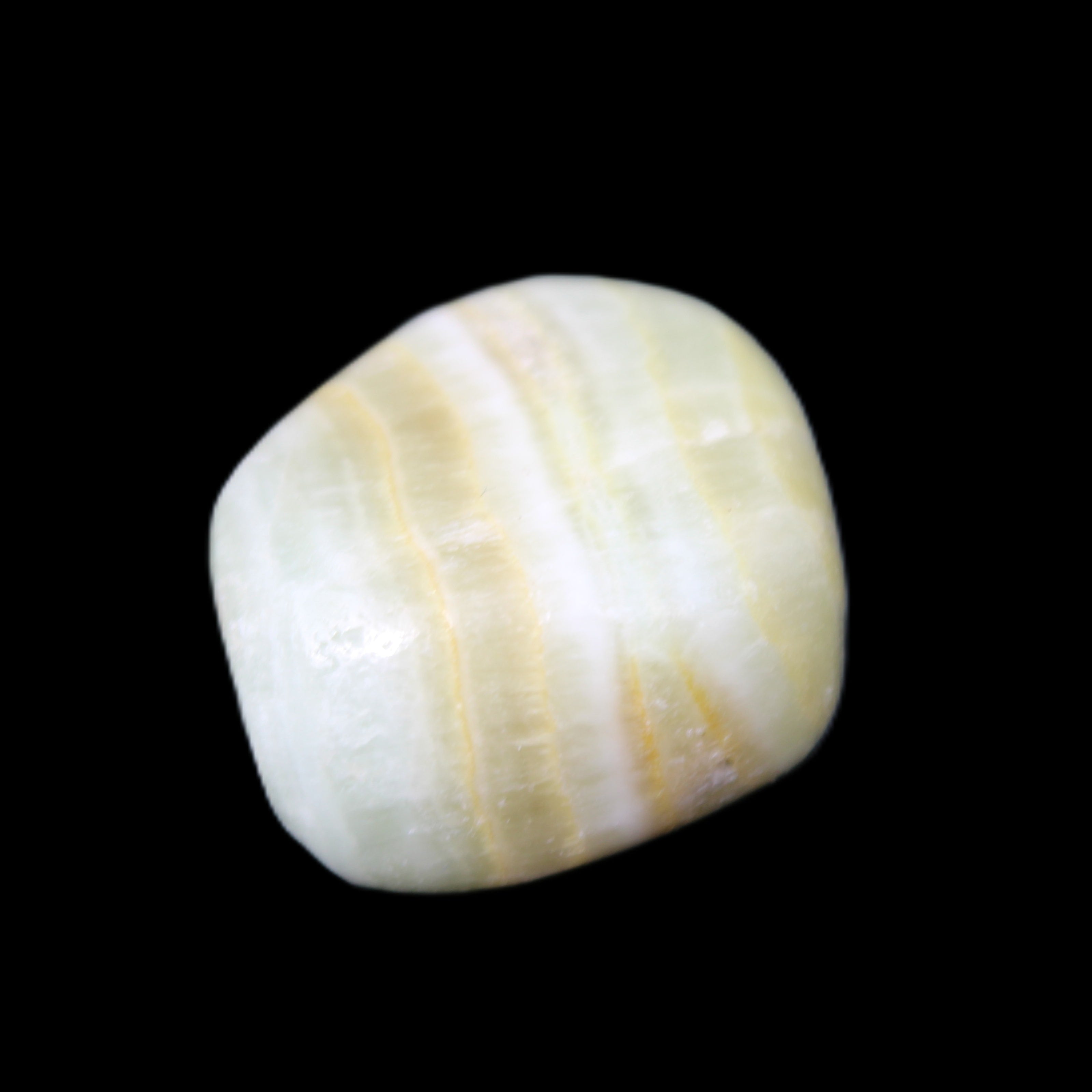 Pistachio Calcite tumbled stone 25-40mm 20-30g in sunlight - Rocks and Things Store