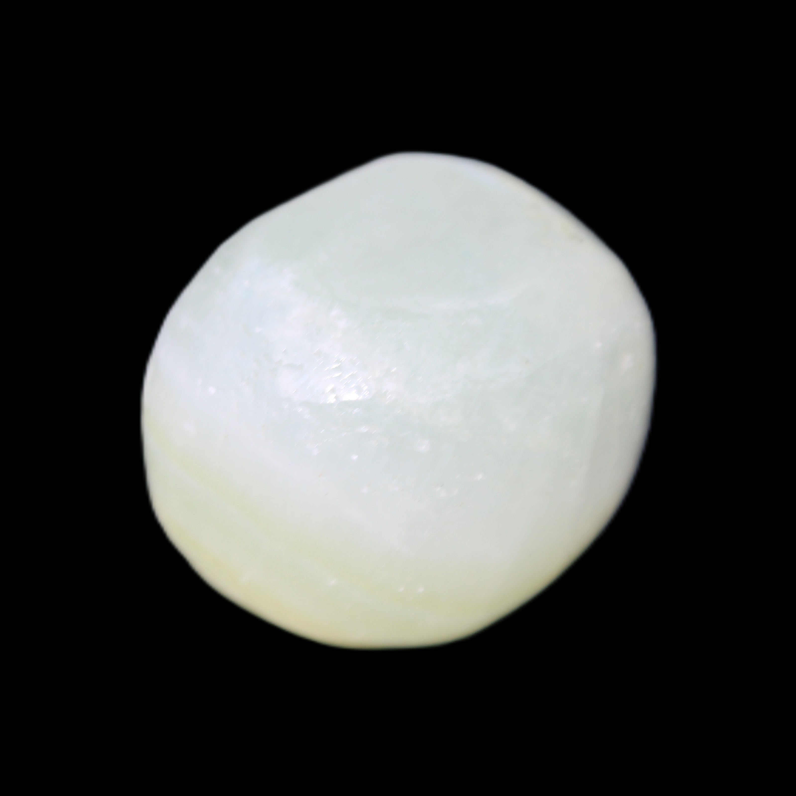 Pistachio Calcite tumbled stone 25-32mm 21-32g in sunlight - Rocks and Things Store
