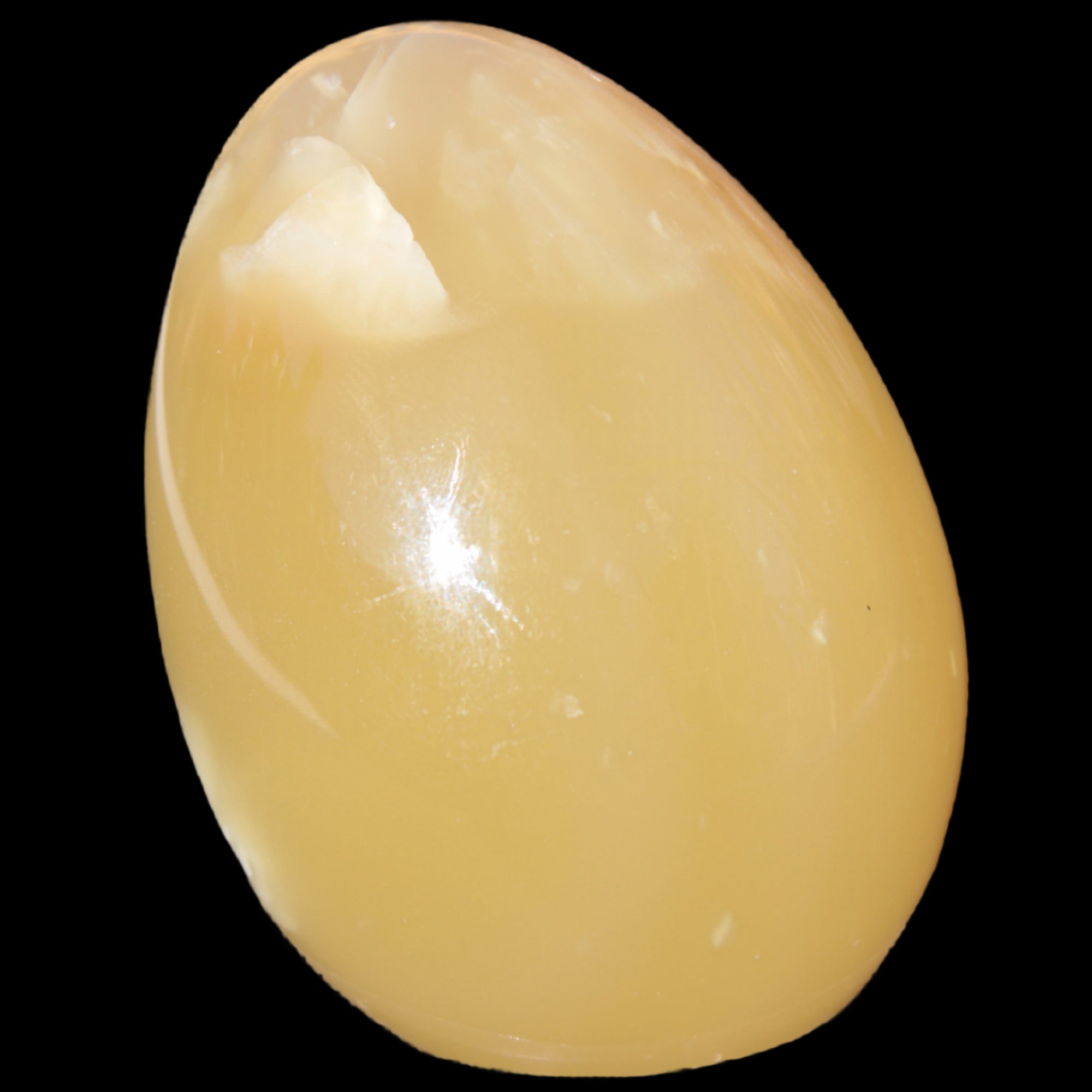Honey Calcite Egg 47*72mm 252.4g in sunlight - Rocks and Things Store