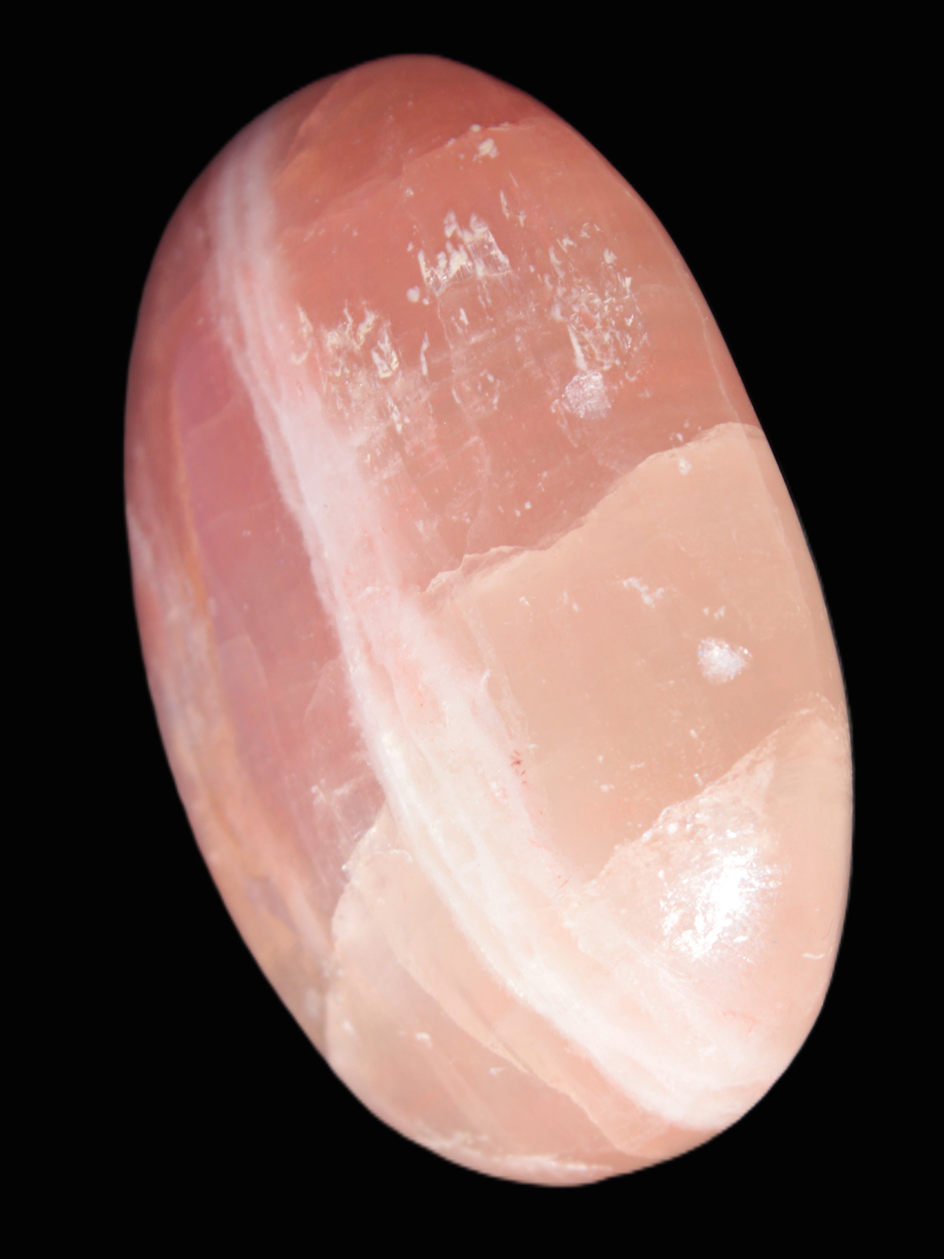 Pink Sorbet Calcite palm stone 57-61mm 71-117g in sunlight - Rocks and Things Store