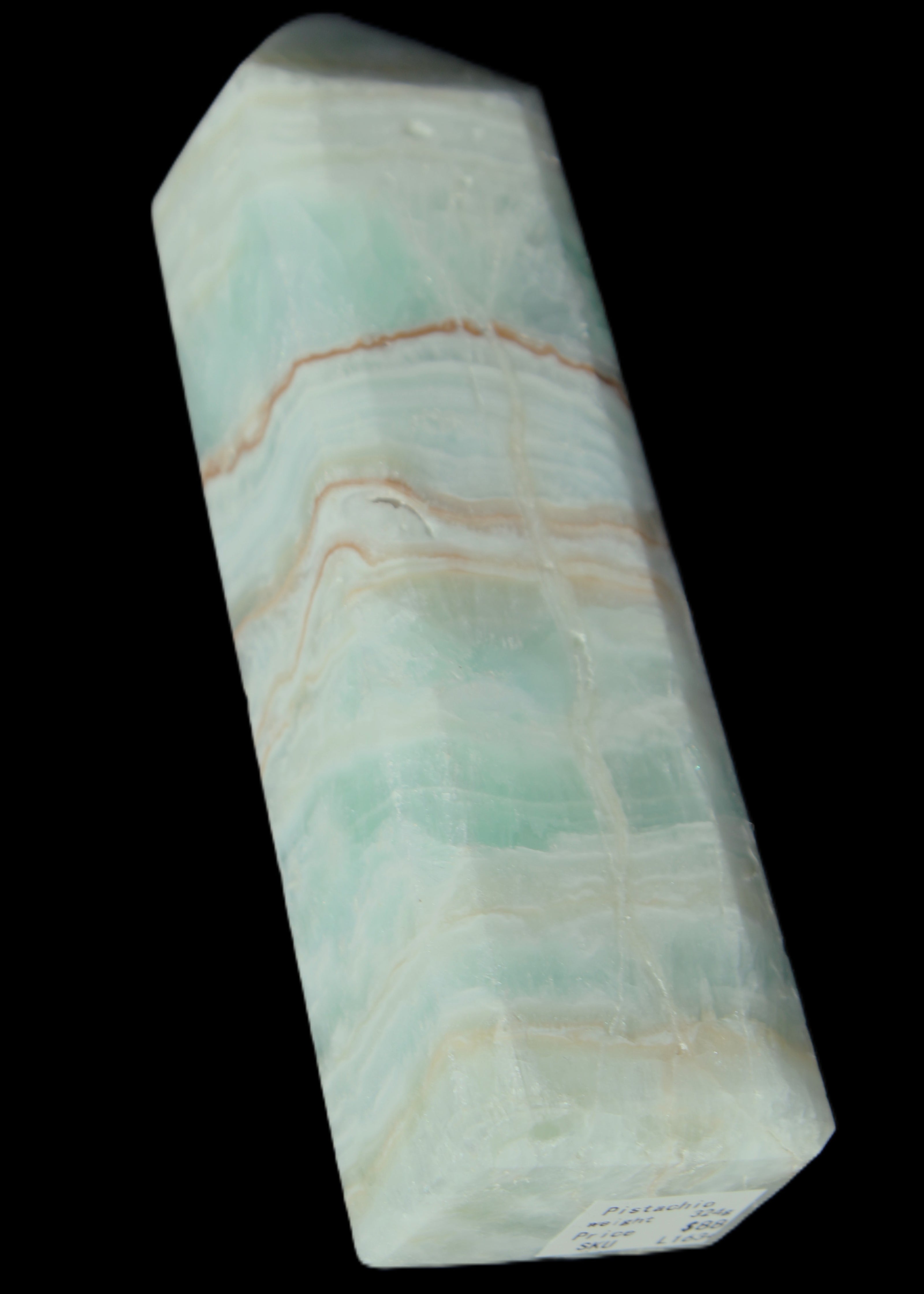 Pistachio Calcite obelisk 131*37*30mm 324g in sunlight - Rocks and Things Store