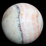 Rhodochrosite sphere 320g in sunlight - Rocks and Things Store