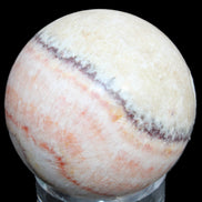 Rhodochrosite sphere 320g in sunlight - Rocks and Things Store