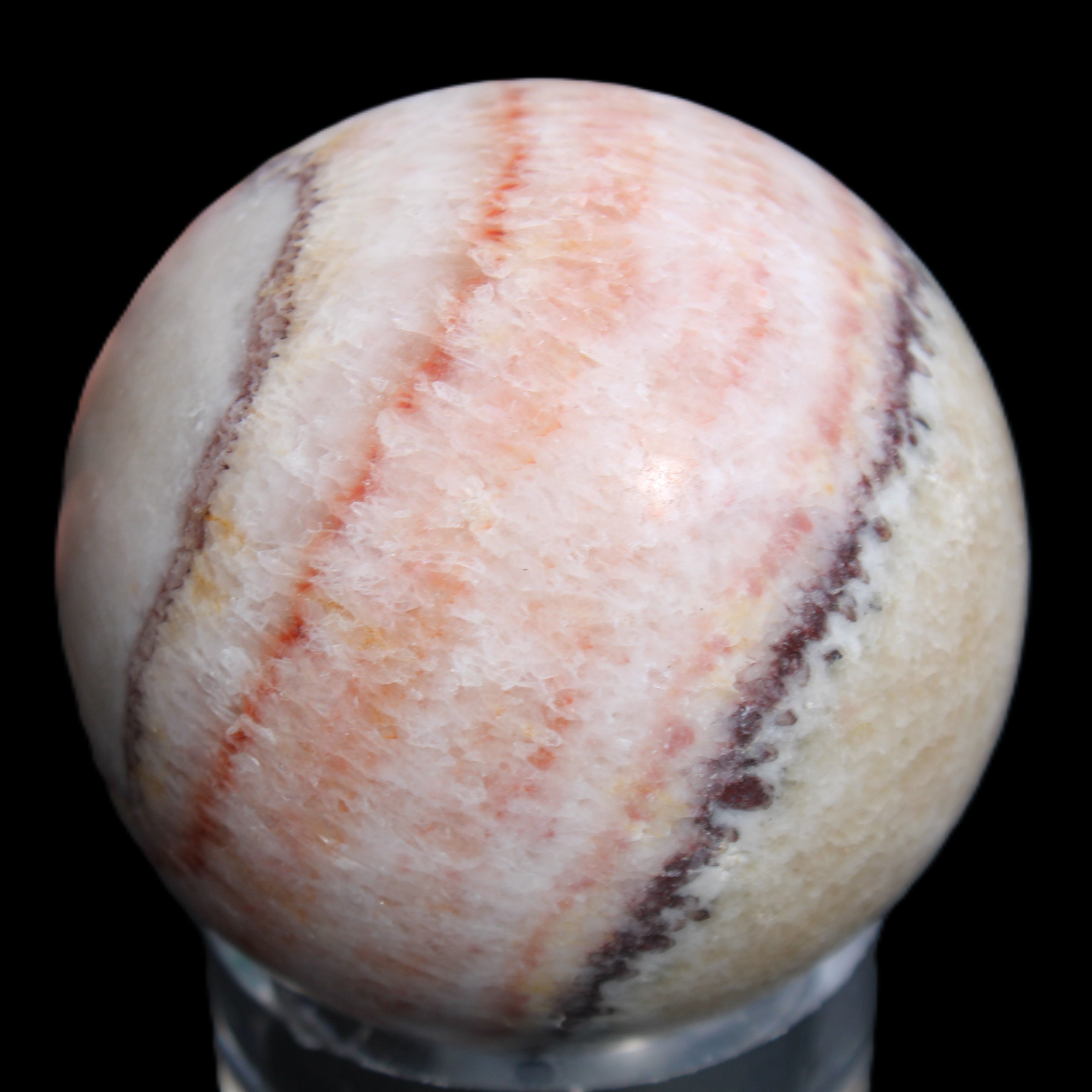 Rhodochrosite sphere 320g in sunlight - Rocks and Things Store