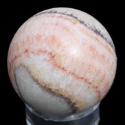 Rhodochrosite sphere 320g in sunlight - Rocks and Things Store