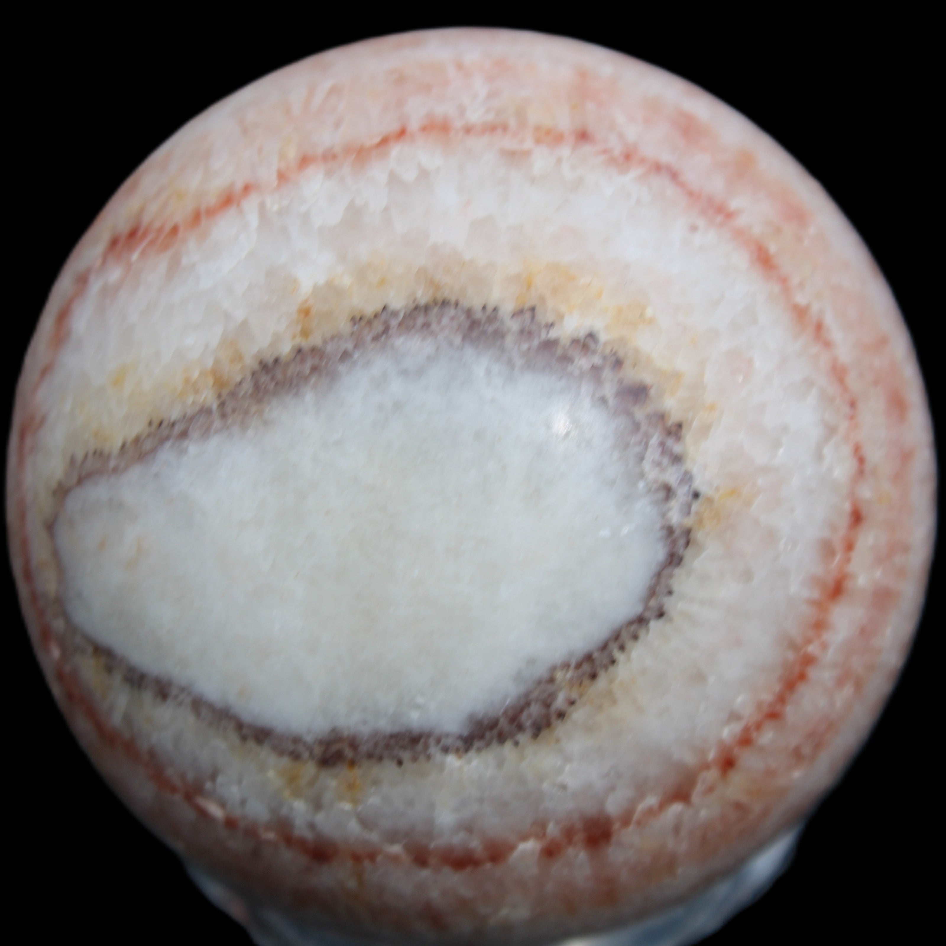 Rhodochrosite sphere 320g in sunlight - Rocks and Things Store