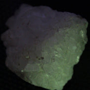 Calcite UV-reactive crystal cluster 130g in UV light 365nm