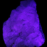 Calcite UV-reactive crystal cluster 130g in UV light 395nm