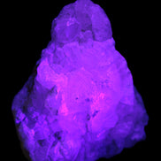 Calcite UV-reactive crystal cluster 130g in UV light 395nm