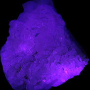 Calcite UV-reactive crystal cluster 130g in UV light 395nm