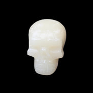 Honey Calcite skull hand-carved 55*47*38mm 183g in sunlight - Rocks and Things Store