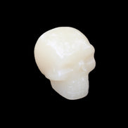 Honey Calcite skull hand-carved 55*47*38mm 183g in sunlight - Rocks and Things Store