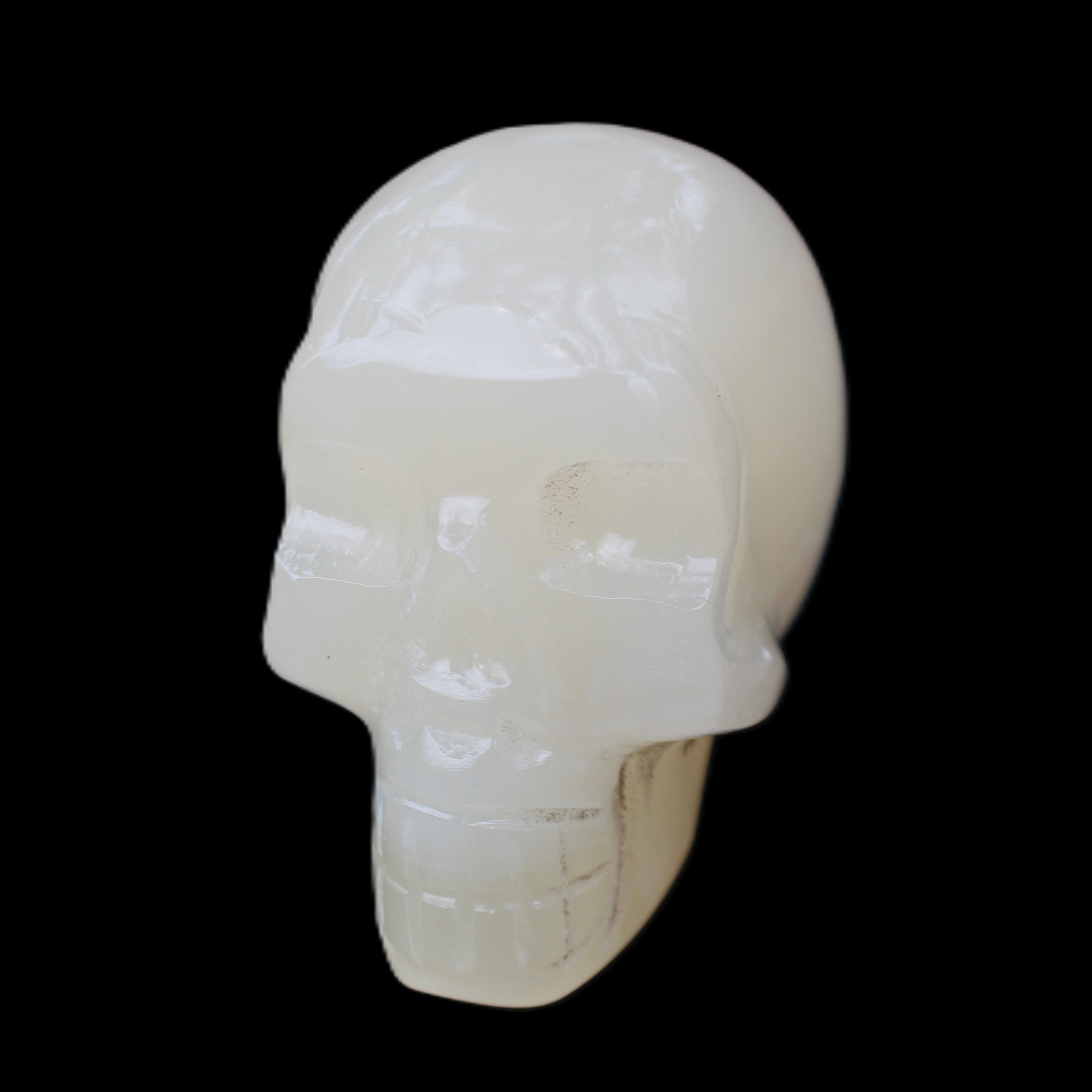 Honey Calcite skull hand-carved 55*47*38mm 183g in sunlight - Rocks and Things Store