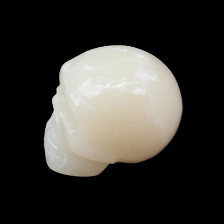 Honey Calcite skull hand-carved 55*47*38mm 183g in sunlight - Rocks and Things Store