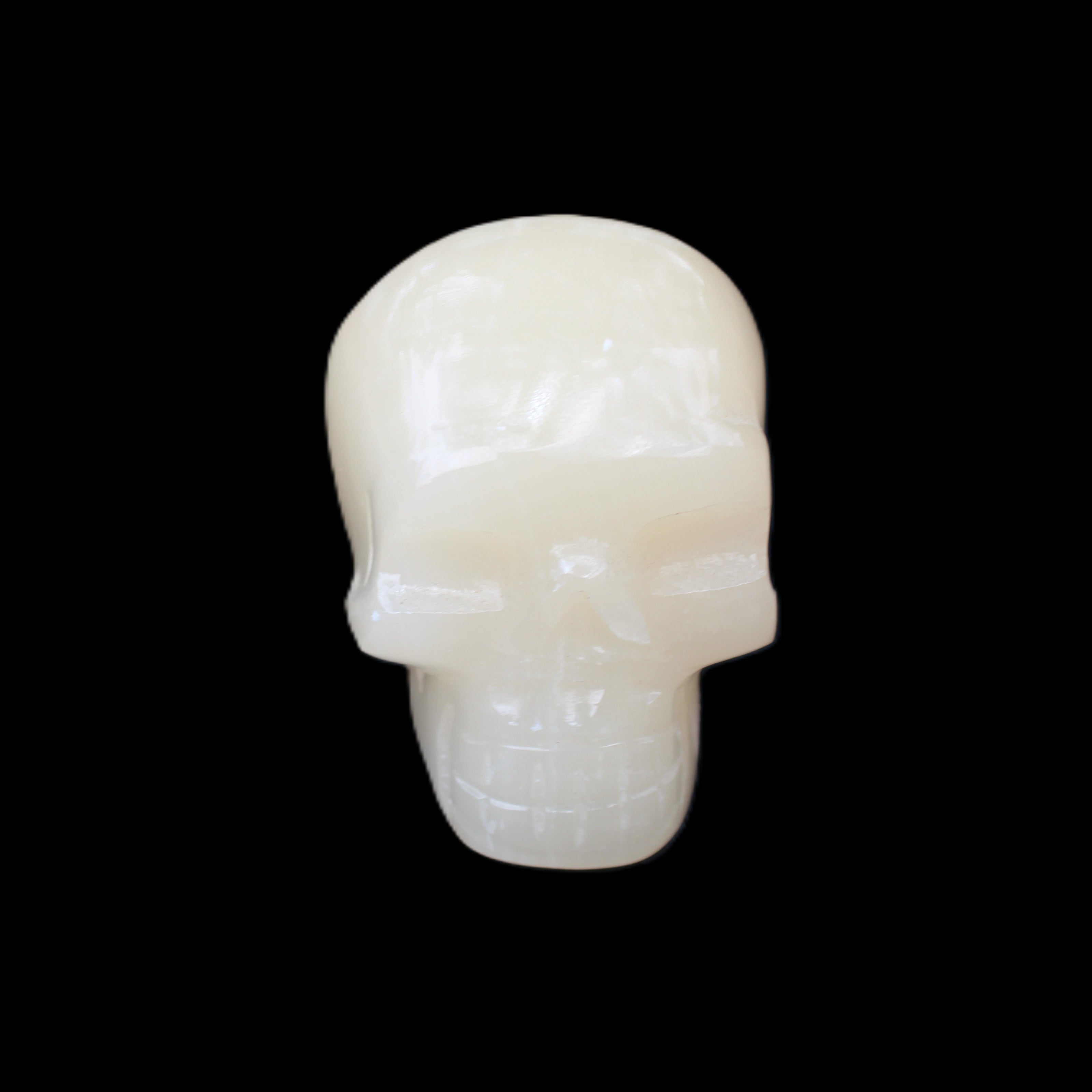 Honey Calcite skull hand-carved 55*47*38mm 183g in sunlight - Rocks and Things Store