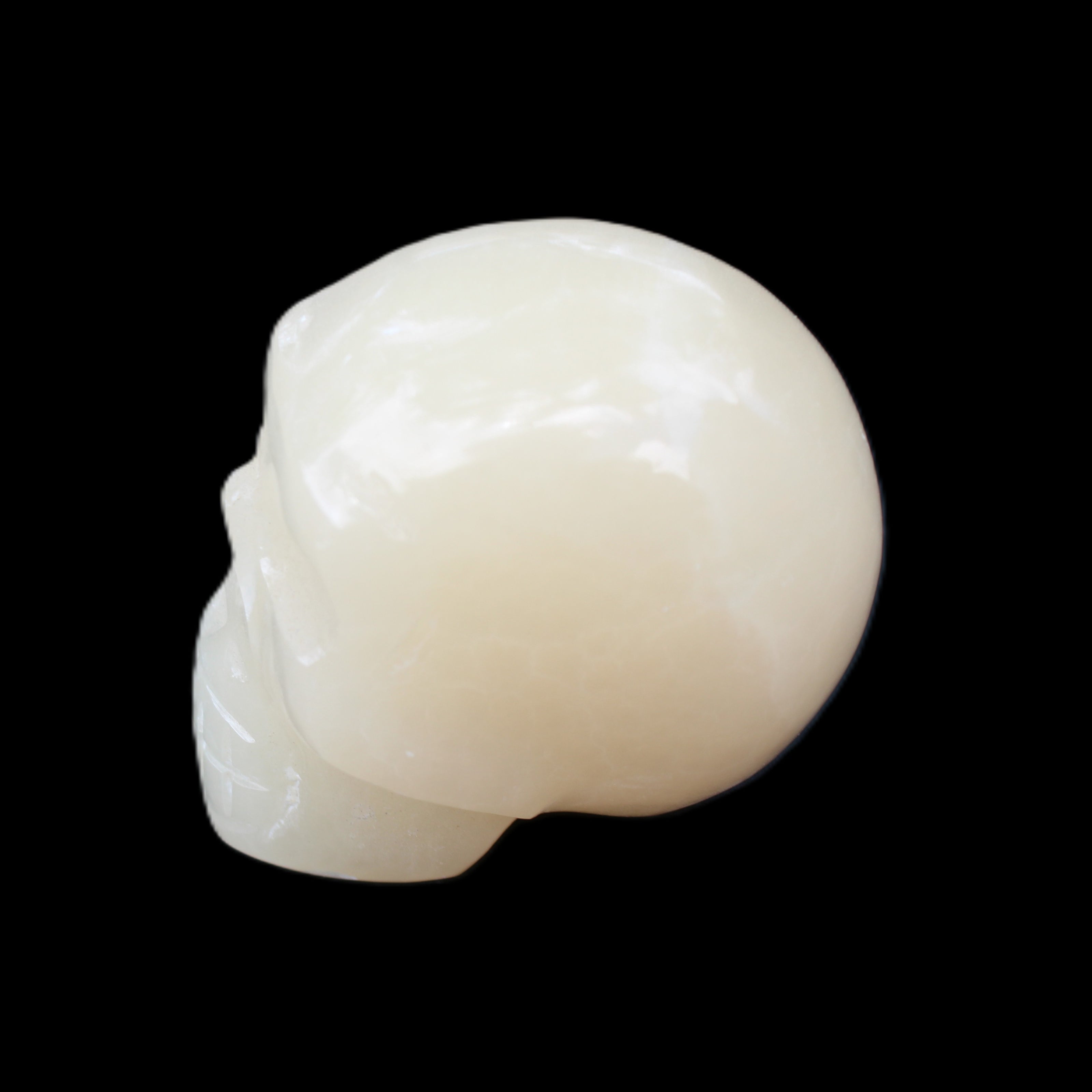 Honey Calcite skull hand-carved 55*47*38mm 183g in sunlight - Rocks and Things Store