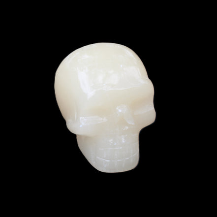 Honey Calcite skull hand-carved 55*47*38mm 183g in sunlight - Rocks and Things Store