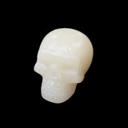 Honey Calcite skull hand-carved 55*47*38mm 183g in sunlight - Rocks and Things Store