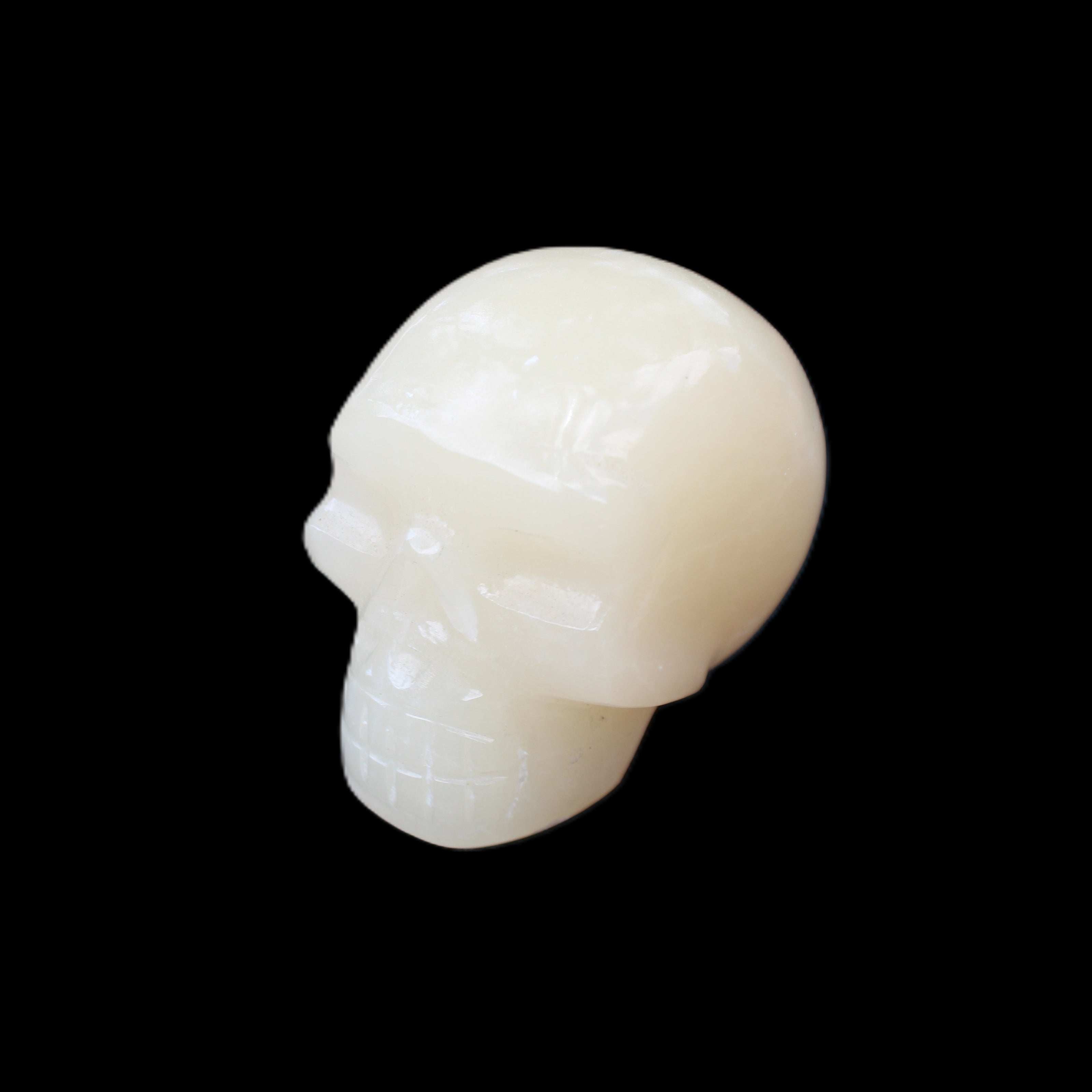 Honey Calcite skull hand-carved 55*47*38mm 183g in sunlight - Rocks and Things Store