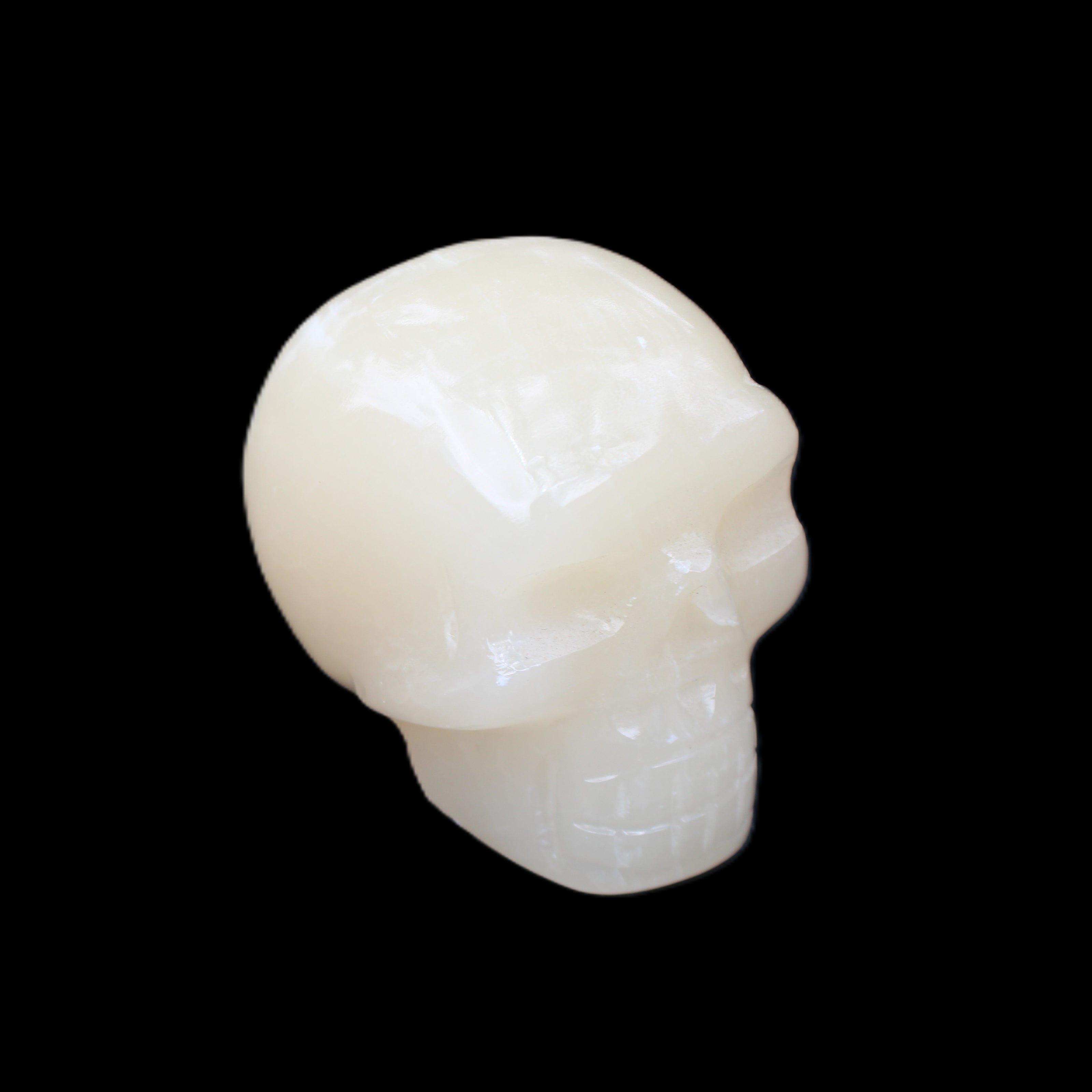 Honey Calcite skull hand-carved 55*47*38mm 183g in sunlight - Rocks and Things Store