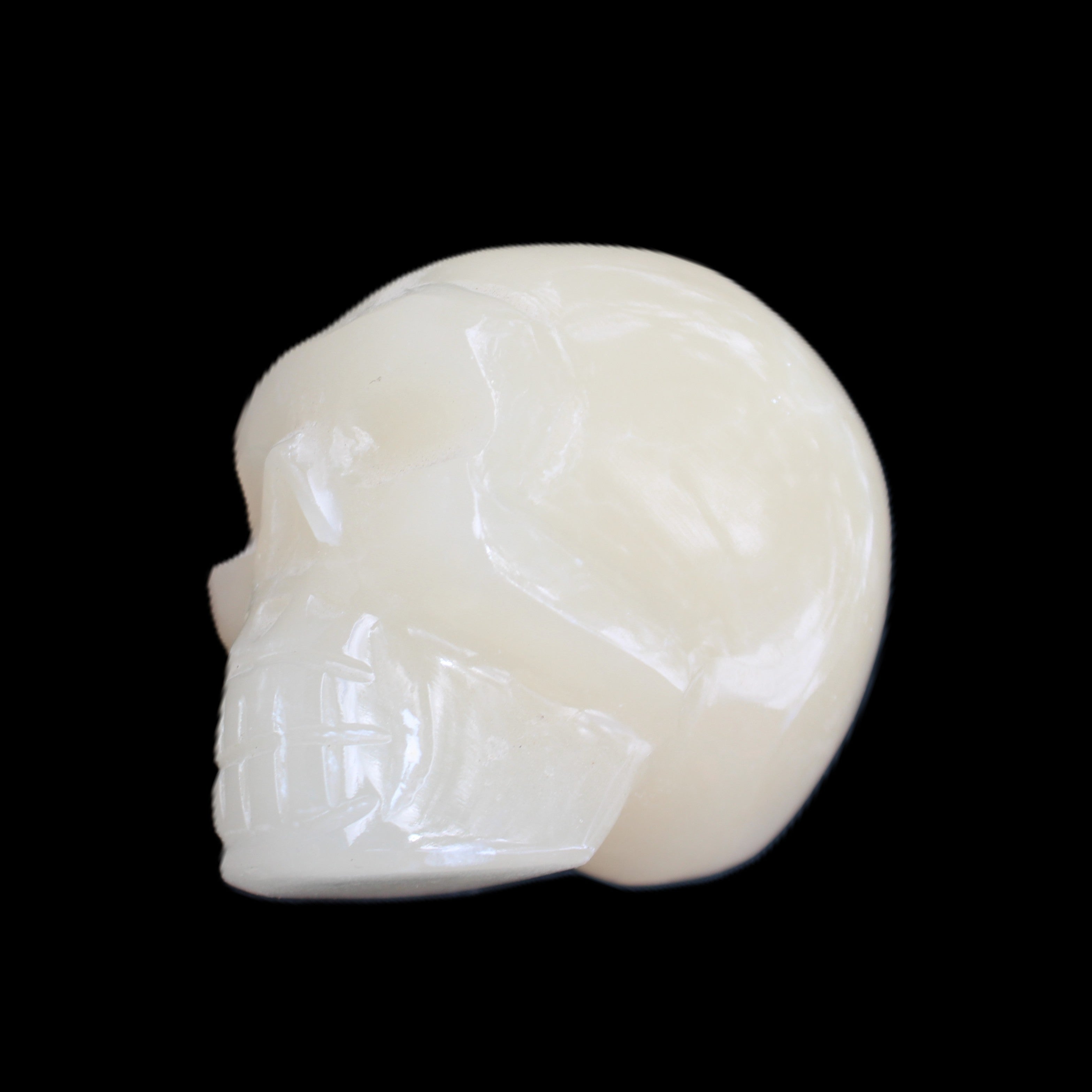 Honey Calcite skull hand-carved 55*47*38mm 183g in sunlight - Rocks and Things Store