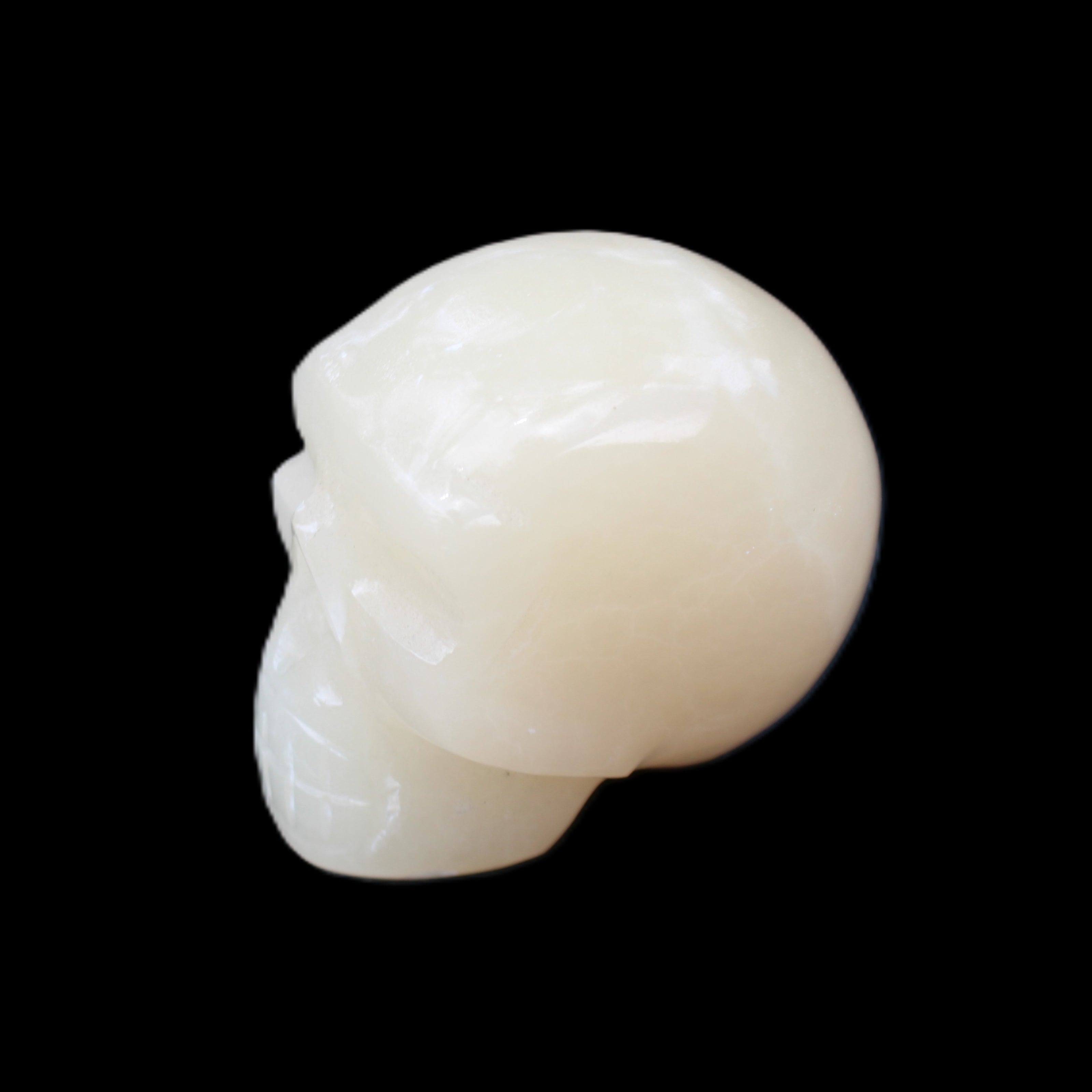 Honey Calcite skull hand-carved 55*47*38mm 183g in sunlight - Rocks and Things Store