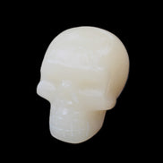 Honey Calcite skull hand-carved 55*47*38mm 183g in sunlight - Rocks and Things Store