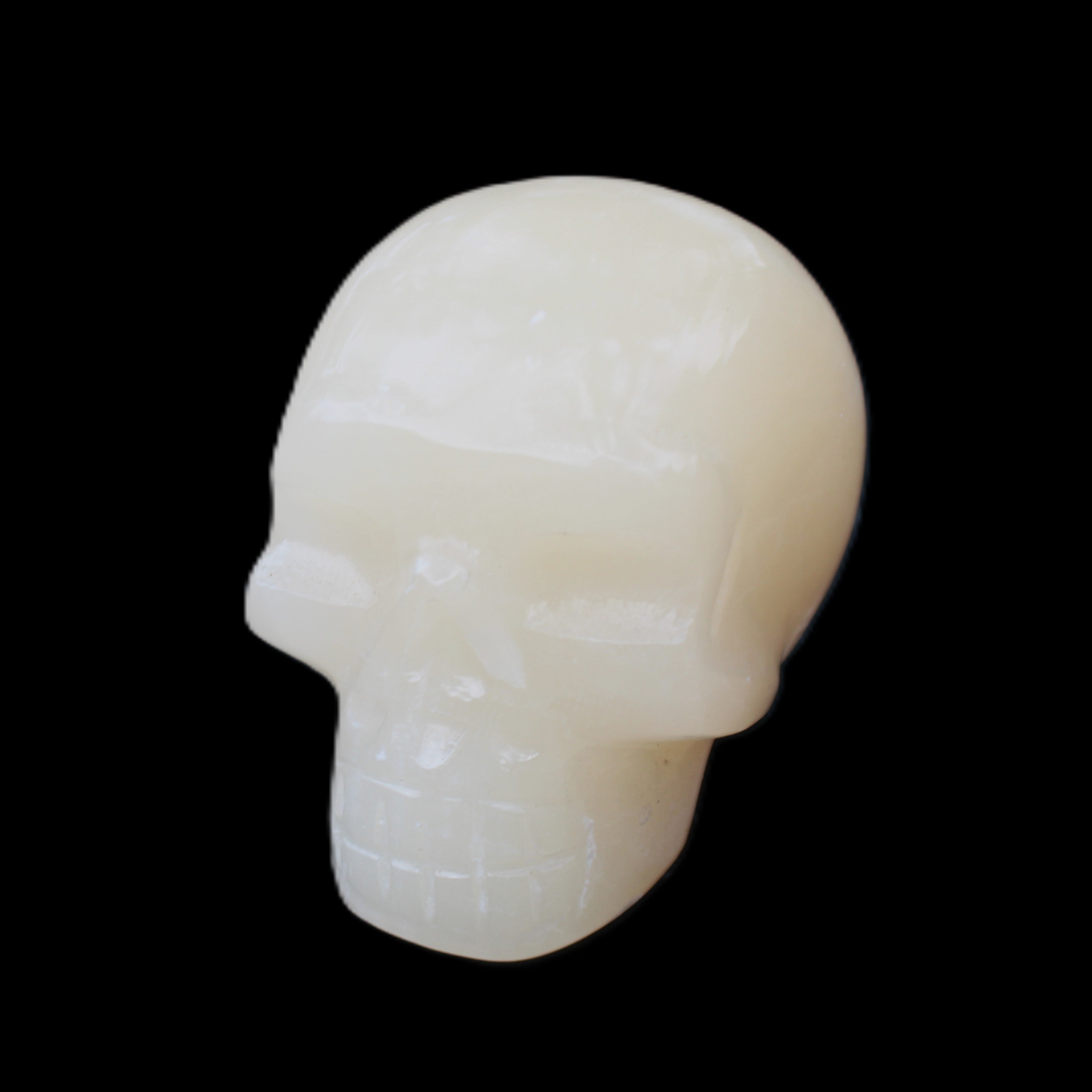 Honey Calcite skull hand-carved 55*47*38mm 183g in sunlight - Rocks and Things Store