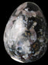 Indigo Gabbro Mystic Merlinite egg 111g in sunlight - Rocks and Things Store