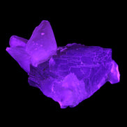 Clear Yellow Fluorite with 45mm dog-tooth Calcite 98*76*55mm 286g in UV light - Rocks and Things Store