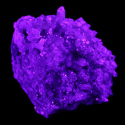 Calcite cluster 75g in UV light - Rocks and Things Store