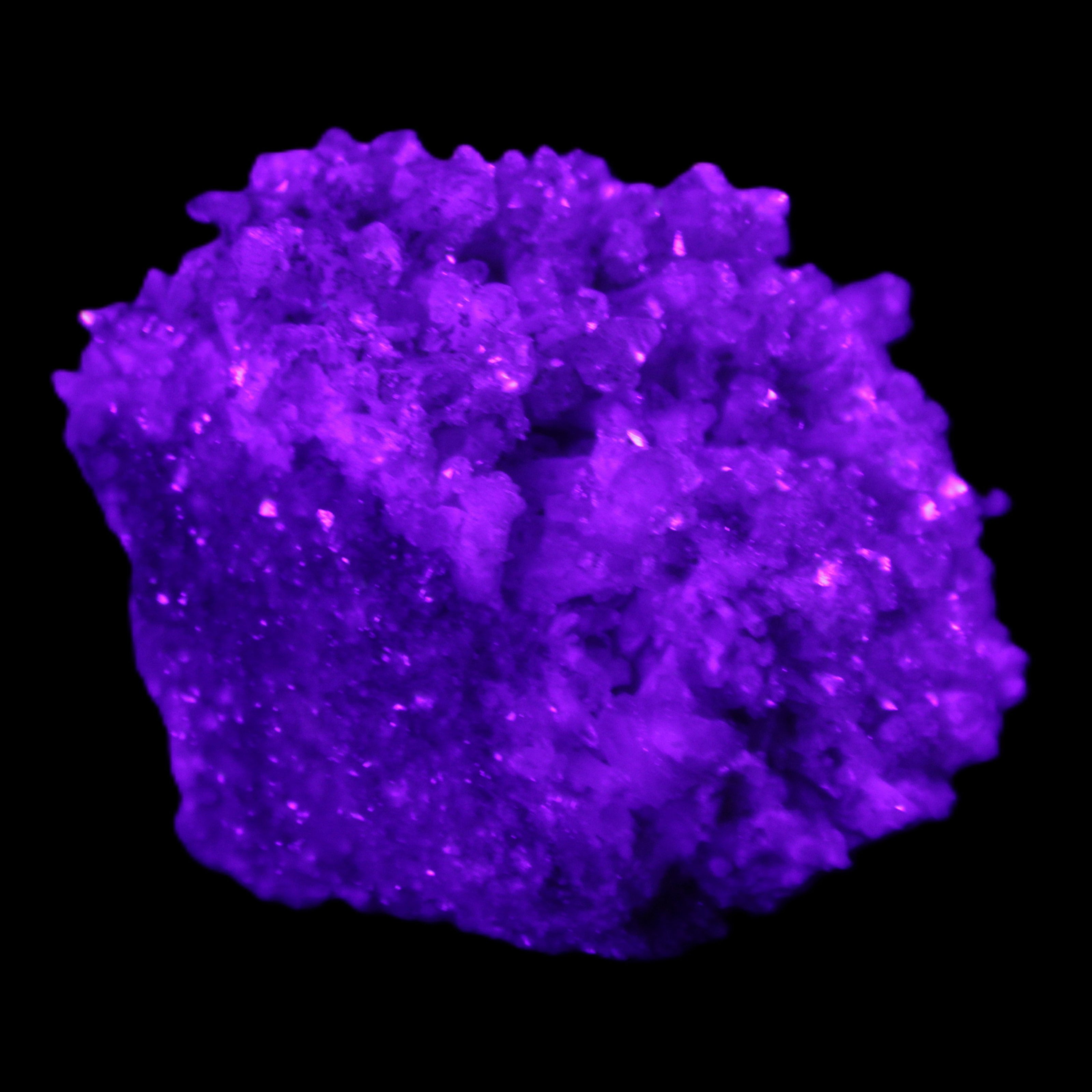 Calcite cluster 75g in UV light - Rocks and Things Store