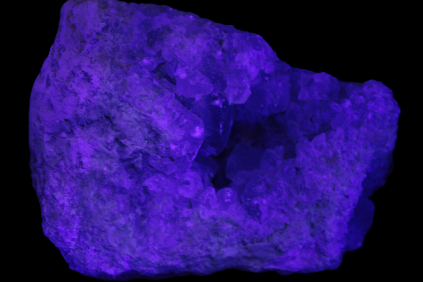 Celestite geode cluster 3840g in UV light