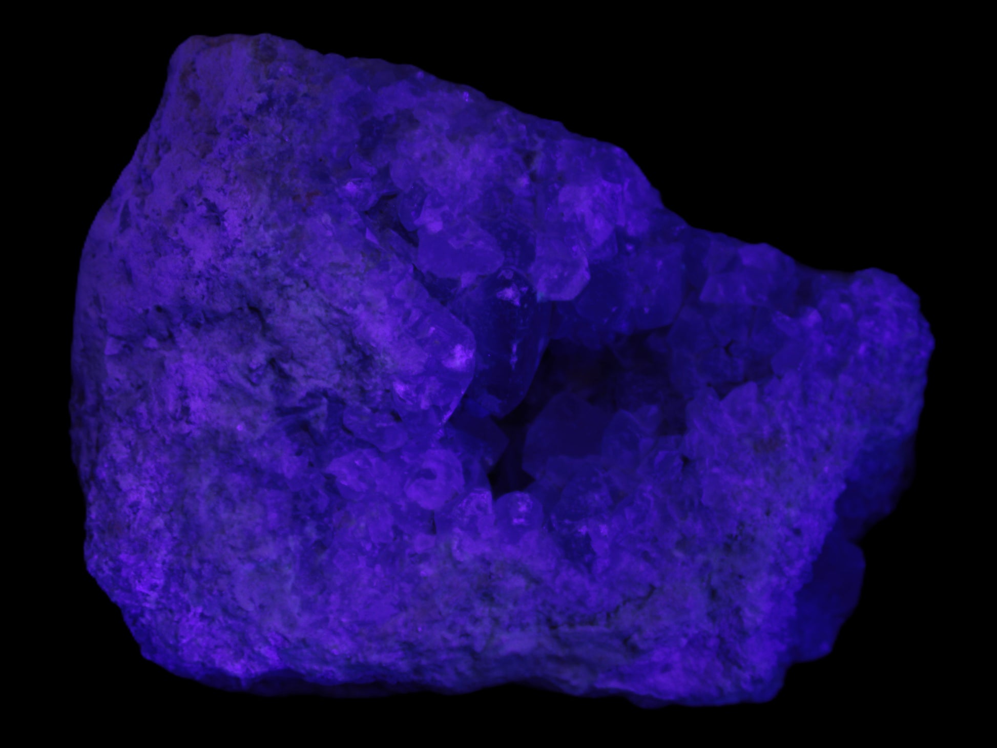 Celestite geode cluster 3840g in UV light