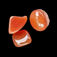 Red Agate 3/4 tumbled tiny stones 7-10g in sunlight - Rocks and Things Store