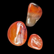 Red Agate 3/4 tumbled tiny stones 7-10g in sunlight - Rocks and Things Store
