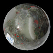 African Bloodstone sphere 84mm 831g in sunlight - Rocks and Things Store