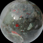 African Bloodstone sphere 84mm 831g in sunlight - Rocks and Things Store