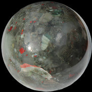 African Bloodstone sphere 84mm 831g in sunlight - Rocks and Things Store