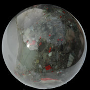 African Bloodstone sphere 84mm 831g in sunlight - Rocks and Things Store