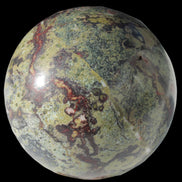Dragons Blood Stone sphere 83mm 928g in sunlight - Rocks and Things Store