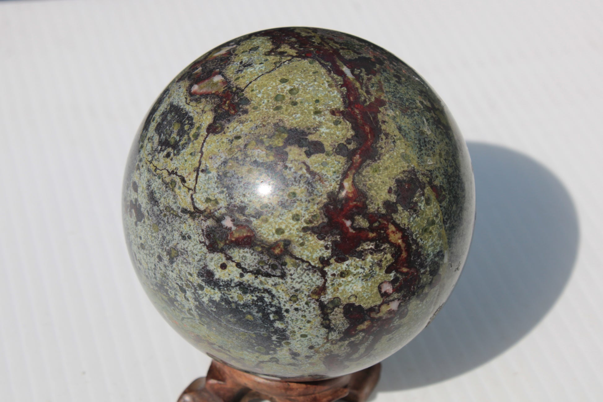 Dragons Blood Stone sphere 83mm 928g Rocks and Things