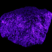 Olivine pyroclastic volcanic bomb from Central Victoria 116*81*65mm 930g in UV light - Rocks and Things Store