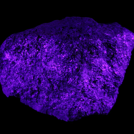 Olivine pyroclastic volcanic bomb from Central Victoria 116*81*65mm 930g in UV light - Rocks and Things Store