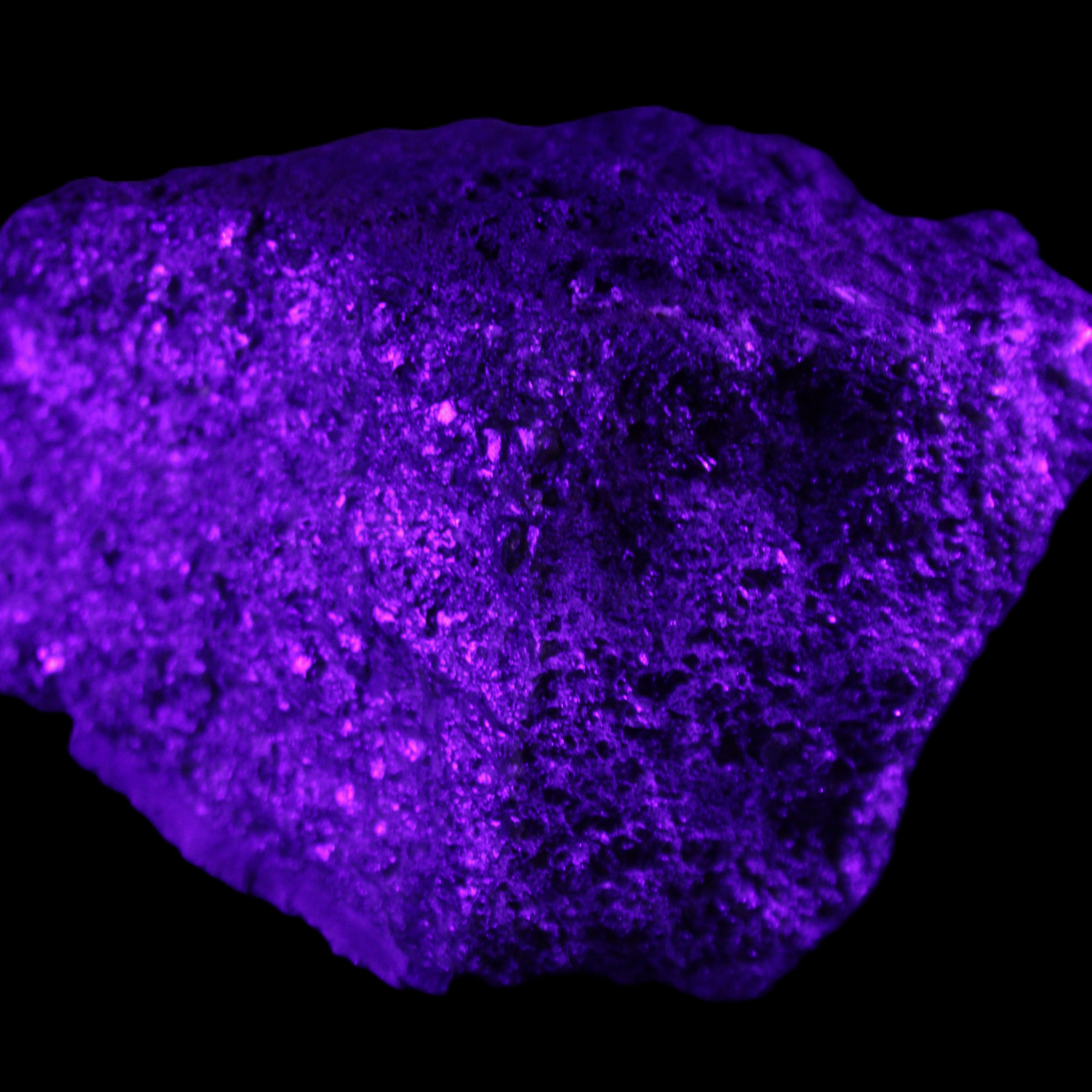 Olivine pyroclastic volcanic bomb from Central Victoria 116*81*65mm 930g in UV light - Rocks and Things Store